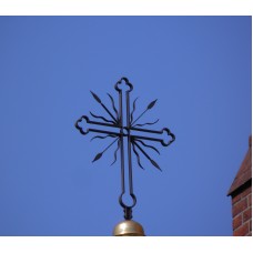 Cross with wavy rays and arrows on top of a steeple